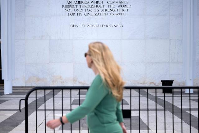 A woman walks past the Kennedy Center in Washington, DC, on June 15, 2026, after a judge ordered the removal of US President Donald Trump's name from the building. Workers removed President Donald Trump's name from the facade of the prestigious Kennedy Center in Washington on June 13 -- a stinging defeat for the US leader who has eschewed political tradition to affix his name and likeness across public spaces. (Photo by Brendan Smialowski / AFP)
