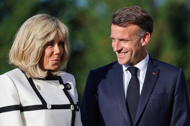 France's President Emmanuel Macron (R) and his wife Brigitte Macron wait for arrival of G7 Heads of State and government for the official greeting during G7 summit, in Evian, eastern France, on June 15, 2026. A G7 summit is set to take place June 15 to 17 in the French town of Evian-les-Bains near Switzerland and it will be attended by country leaders as well as the EU's foreign policy chief and ministers from Brazil, Canada, the United Arab Emirates and Turkey. (Photo by Ludovic MARIN / AFP)