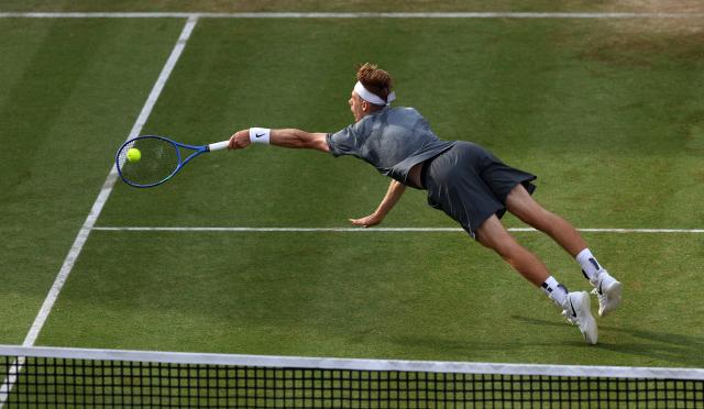 TOPSHOT - Canada's Denis Shapovalov dives to return a shot during the third set tie-break against Britain's Jack Pinnington Jones during their men's singles round of 32 tennis match on day one of the ATP HSBC Championships at Queen's Club in west London on June 15, 2026. Shapovalov won the match 6-4, 4-6, 7-6. (Photo by Adrian Dennis / AFP)