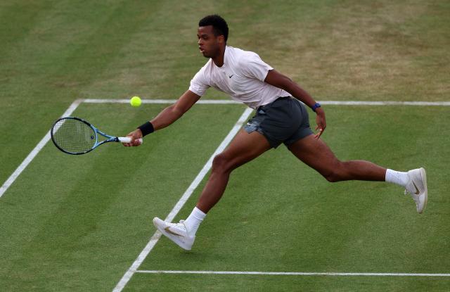 France's Giovanni Mpetshi Perricard returns against France's Corentin Moutet during their men's singles round of 32 tennis match on day one of the ATP HSBC Championships at Queen's Club in west London on June 15, 2026. (Photo by Adrian Dennis / AFP)