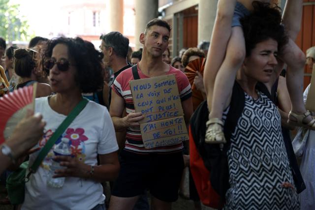 A protestor holds a sign which reads "We are the voice of those who have none left, justice, I am ashamed of you" during a gathering to demand a law against violence towards minors outside the Toulouse courthouse, in Toulouse, on June 15, 2026. (Photo by Valentine CHAPUIS / AFP)