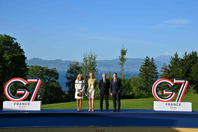 France's President Emmanuel Macron (R) and his wife Brigitte Macron (L) pose with Canada's Prime Minister Mark Carney (C-R) and his wife Diana Fox Carney during the official greeting as part of the G7 summit, in Evian, eastern France, on June 15, 2026. A G7 summit is set to take place June 15 to 17 in the French town of Evian-les-Bains near Switzerland and it will be attended by country leaders as well as the EU's foreign policy chief and ministers from Brazil, Canada, the United Arab Emirates and Turkey. (Photo by Mandel NGAN / AFP)