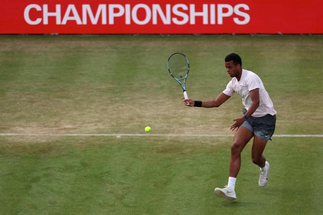 France's Giovanni Mpetshi Perricard returns against France's Corentin Moutet during their men's singles round of 32 tennis match on day one of the ATP HSBC Championships at Queen's Club in west London on June 15, 2026. (Photo by Adrian Dennis / AFP)