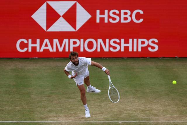 France's Corentin Moutet serves against France's Giovanni Mpetshi Perricard during their men's singles round of 32 tennis match on day one of the ATP HSBC Championships at Queen's Club in west London on June 15, 2026. (Photo by Adrian Dennis / AFP)