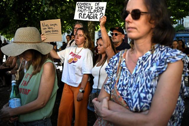A protester holds a placard reading "How many victims do you need to react ?" during a gathering to demand a law against violence on minors outside the Judicial court in Bordeaux, southwestern France on June 15, 2026. (Photo by Christophe ARCHAMBAULT / AFP)