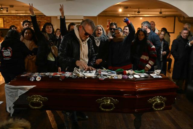 Relatives and friends of Taty Almeida, the late president of the Madres de Plaza de Mayo human rights association, attend her wake at FOETRA union office in Buenos Aires, on June 15, 2026. Almeida died on June 14, 2026 at the age of 95, after more than four decades as one of the most prominent voices against the crimes of Argentina’s last dictatorship since she lost in 1975 her son Alejandro, a member of the guerrilla group Revolutionary People’s Army (ERP), kidnapped by the right-wing paramilitary organization Triple A.. (Photo by Luis ROBAYO / AFP)