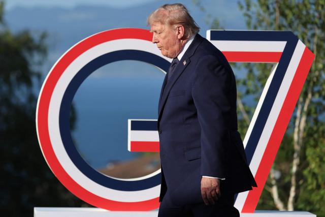 US President Donald Trump arrives for the official greeting during the G7 summit, in Evian, eastern France, on June 15, 2026. A G7 summit is set to take place June 15 to 17 in the French town of Evian-les-Bains near Switzerland and it will be attended by country leaders as well as the EU's foreign policy chief and ministers from Brazil, Canada, the United Arab Emirates and Turkey. (Photo by Ludovic MARIN / POOL / AFP)