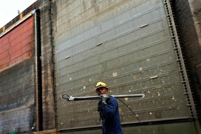 A Panama Canal worker carries out routine maintenance inside one of the chambers at the Gatun Locks in the province of Colon, located about 80 kilometers north of Panama City, on June 15, 2026. These maintenance operations are carried out periodically across the interoceanic waterway to ensure the safe and efficient transit of vessels along one of the world's most important and heavily traveled maritime trade routes. (Photo by ARNULFO FRANCO / AFP)
