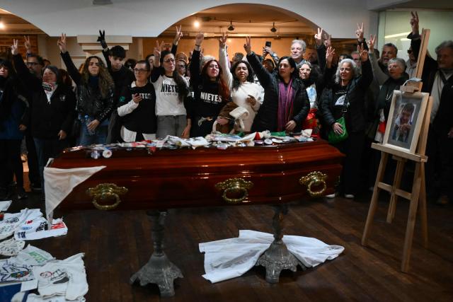 Relatives and friends of Taty Almeida, the late president of the Madres de Plaza de Mayo human rights association, gesture during her wake at the telecommunications union office (FOETRA) in Buenos Aires, on June 15, 2026. Almeida died on June 14, 2026 at the age of 95, after more than four decades as one of the most prominent voices against the crimes of Argentina’s last dictatorship since she lost in 1975 her son Alejandro, a member of the guerrilla group Revolutionary People’s Army (ERP), kidnapped by the right-wing paramilitary organization Triple A.. (Photo by Luis ROBAYO / AFP)