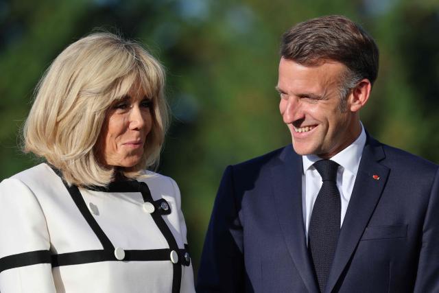 France's President Emmanuel Macron (R) and his wife Brigitte Macron wait for arrival of G7 Heads of State and government for the official greeting during G7 summit, in Evian, eastern France, on June 15, 2026. A G7 summit is set to take place June 15 to 17 in the French town of Evian-les-Bains near Switzerland and it will be attended by country leaders as well as the EU's foreign policy chief and ministers from Brazil, Canada, the United Arab Emirates and Turkey. (Photo by Ludovic MARIN / AFP)