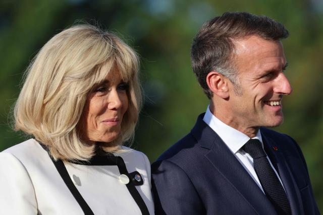 France's President Emmanuel Macron (R) and his wife Brigitte Macron wait for arrival of G7 Heads of State and government for the official greeting during G7 summit, in Evian, eastern France, on June 15, 2026. A G7 summit is set to take place June 15 to 17 in the French town of Evian-les-Bains near Switzerland and it will be attended by country leaders as well as the EU's foreign policy chief and ministers from Brazil, Canada, the United Arab Emirates and Turkey. (Photo by Ludovic MARIN / AFP)