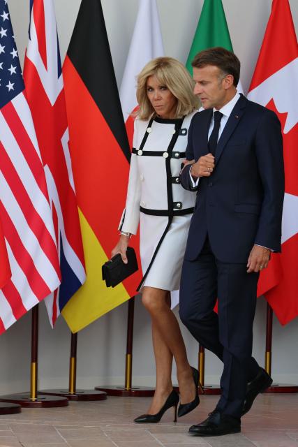 France's President Emmanuel Macron (R) and his wife Brigitte Macron arrive for the official greeting during the G7 summit, in Evian, eastern France, on June 15, 2026. A G7 summit is set to take place June 15 to 17 in the French town of Evian-les-Bains near Switzerland and it will be attended by country leaders as well as the EU's foreign policy chief and ministers from Brazil, Canada, the United Arab Emirates and Turkey. (Photo by Ludovic MARIN / AFP)