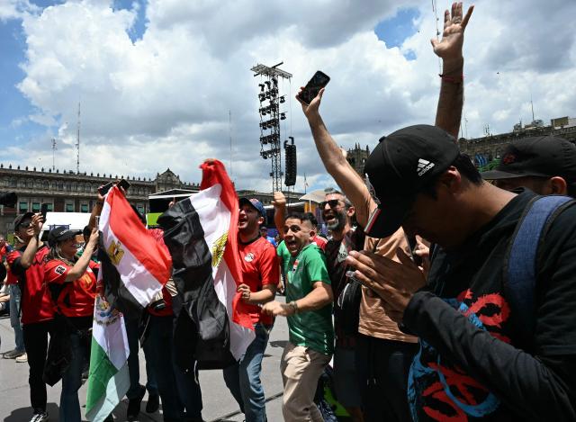 Fans of Egypt celebrate after thei team scored while attending the screening of the 2026 World Cup football tournament Group G match between Belgium and Egypt at the FIFA Fan Festival at Zocalo square in Mexico City on June 15, 2026. (Photo by YURI CORTEZ / AFP)