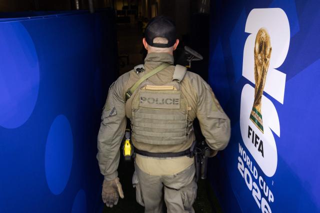 An Inglewood police officer with the SWAT leaves the pitch ahead of the 2026 World Cup Group G football match between Iran and New Zealand at the Los Angeles Stadium in Inglewood on June 15, 2026.  (Photo by ETIENNE LAURENT / AFP)