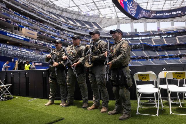 Inglewood police officers with the SWAT unit pose for a photo ahead of the 2026 World Cup Group G football match between Iran and New Zealand at the Los Angeles Stadium in Inglewood on June 15, 2026.  (Photo by ETIENNE LAURENT / AFP)