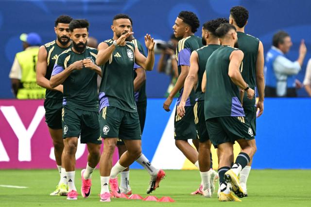 Saudi Arabia players warm up ahead of the 2026 World Cup Group H football match between Saudi Arabia and Uruguay at the Miami Stadium in Miami Gardens on June 15, 2026.  (Photo by CHANDAN KHANNA / AFP)