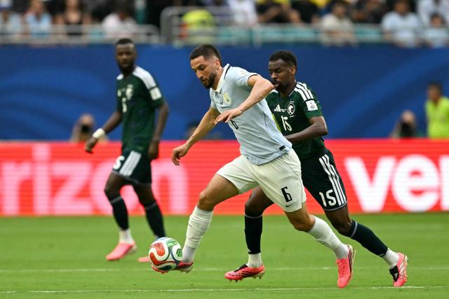 Uruguay's midfielder #06 Rodrigo Bentancur and Saudi Arabia's midfielder #15 Abdullah Al-Khaibari fight for the ball during the 2026 World Cup Group H football match between Saudi Arabia and Uruguay at the Miami Stadium in Miami Gardens on June 15, 2026.  (Photo by CHANDAN KHANNA / AFP)