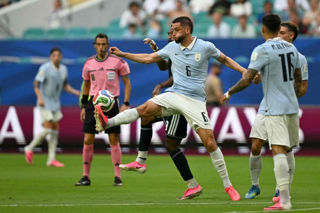 Uruguay's midfielder #06 Rodrigo Bentancur (front) and Saudi Arabia's forward #09 Feras Al-Brikan fight for the ball during the 2026 World Cup Group H football match between Saudi Arabia and Uruguay at the Miami Stadium in Miami Gardens on June 15, 2026.  (Photo by CHANDAN KHANNA / AFP)