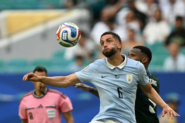Uruguay's midfielder #06 Rodrigo Bentancur (front) and Saudi Arabia's forward #09 Feras Al-Brikan fight for the ball during the 2026 World Cup Group H football match between Saudi Arabia and Uruguay at the Miami Stadium in Miami Gardens on June 15, 2026.  (Photo by CHANDAN KHANNA / AFP)