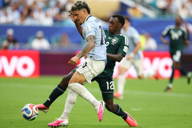 Uruguay's midfielder #20 Maximiliano Araujo and Saudi Arabia's defender #12 Saud Abdulhamid fight for the ball during the 2026 World Cup Group H football match between Saudi Arabia and Uruguay at the Miami Stadium in Miami Gardens on June 15, 2026.  (Photo by PATRICIA DE MELO MOREIRA / AFP)