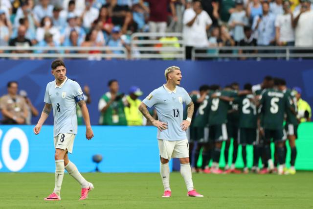Uruguay's defender #13 Guillermo Varela and midfielder #08 Federico Valverde react after conceding a goal during the 2026 World Cup Group H football match between Saudi Arabia and Uruguay at the Miami Stadium in Miami Gardens on June 15, 2026.  (Photo by PATRICIA DE MELO MOREIRA / AFP)