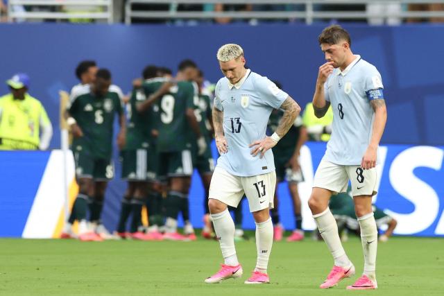 Uruguay's defender #13 Guillermo Varela and midfielder #08 Federico Valverde react after conceding a goal during the 2026 World Cup Group H football match between Saudi Arabia and Uruguay at the Miami Stadium in Miami Gardens on June 15, 2026.  (Photo by PATRICIA DE MELO MOREIRA / AFP)