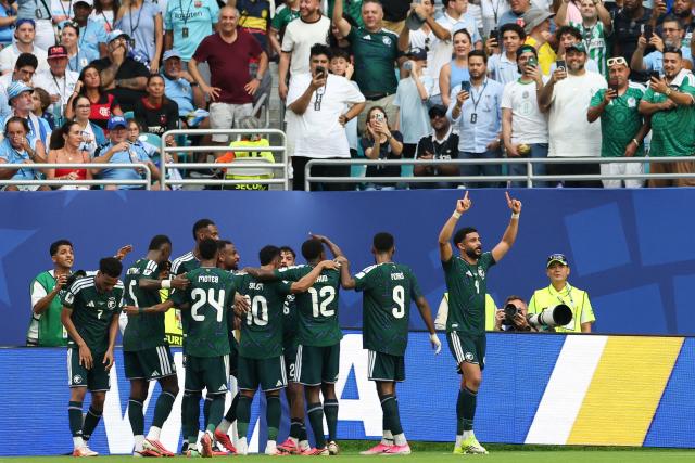 TOPSHOT - Saudi Arabia's defender #04 Abdulelah Al-Amri celebrates with teammates after scoring his team's first goal during the 2026 World Cup Group H football match between Saudi Arabia and Uruguay at the Miami Stadium in Miami Gardens on June 15, 2026.  (Photo by PATRICIA DE MELO MOREIRA / AFP)
