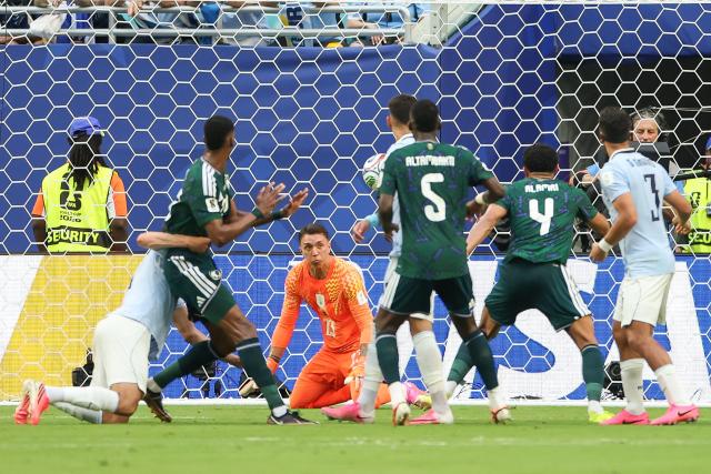 Saudi Arabia's defender #04 Abdulelah Al-Amri prepares to score his team's first goal past Uruguay's goalkeeper #23 Fernando Muslera during the 2026 World Cup Group H football match between Saudi Arabia and Uruguay at the Miami Stadium in Miami Gardens on June 15, 2026.  (Photo by PATRICIA DE MELO MOREIRA / AFP)