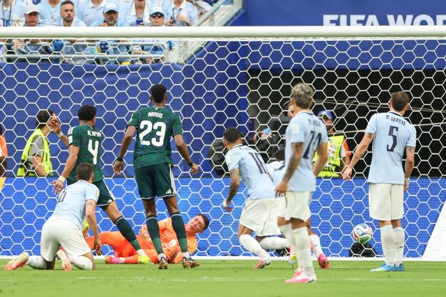 Saudi Arabia's defender #04 Abdulelah Al-Amri scores his team's first goal past Uruguay's goalkeeper #23 Fernando Muslera during the 2026 World Cup Group H football match between Saudi Arabia and Uruguay at the Miami Stadium in Miami Gardens on June 15, 2026.  (Photo by PATRICIA DE MELO MOREIRA / AFP)