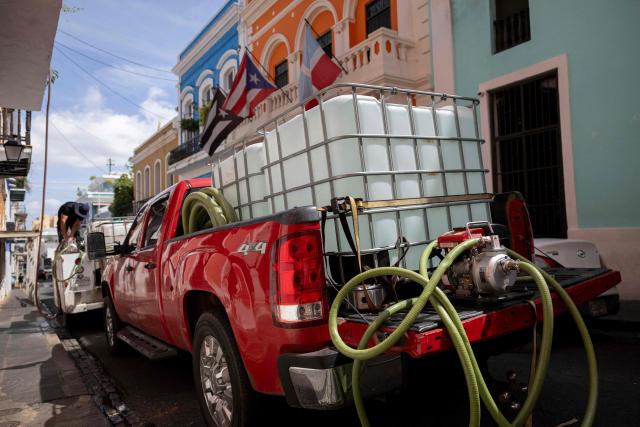 Pickup trucks equipped with water tanks fill restaurants tanks during ongoing water shortages in Old San Juan, Puerto Rico, on June 15, 2026. Three major ruptures in a 72-inch pipeline, detected by authorities on June 10, 2026, has severely disrupted potable water service across the San Juan metropolitan area, affecting more than 100,000 customers. (Photo by Ricardo ARDUENGO / AFP)