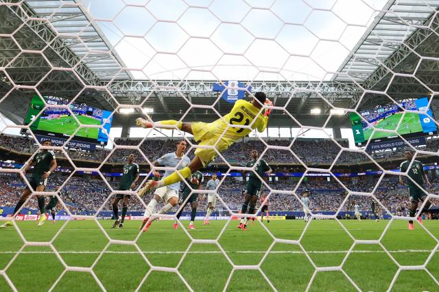 Saudi Arabia's goalkeeper #21 Mohammed Al-Owais catches the ball during the 2026 World Cup Group H football match between Saudi Arabia and Uruguay at the Miami Stadium in Miami Gardens on June 15, 2026.  (Photo by PATRICIA DE MELO MOREIRA / AFP)