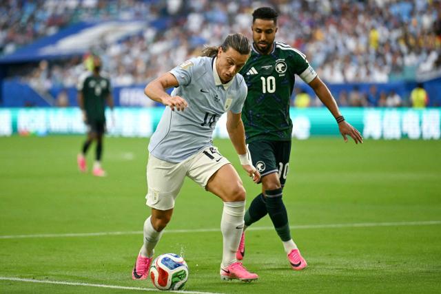 Uruguay's forward #14 Agustin Canobbio and Saudi Arabia's forward #10 Salem Al-Dawsari fight for the ball during the 2026 World Cup Group H football match between Saudi Arabia and Uruguay at the Miami Stadium in Miami Gardens on June 15, 2026.  (Photo by CHANDAN KHANNA / AFP)
