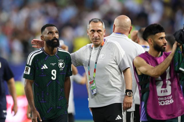 Saudi Arabia's Greek head coach Giorgos Donis talks to his forward #09 Feras Al-Brikan at the end of the 2026 World Cup Group H football match between Saudi Arabia and Uruguay at the Miami Stadium in Miami Gardens on June 15, 2026.  (Photo by PATRICIA DE MELO MOREIRA / AFP)