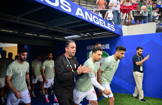 Iran's players walk onto the pitch to warm up ahead of the 2026 World Cup Group G football match between Iran and New Zealand at Los Angeles Stadium in Inglewood on June 15, 2026.  (Photo by Frederic J. Brown / AFP)