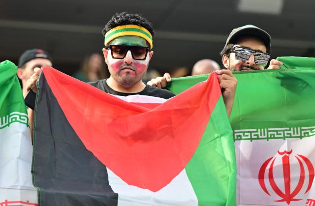 Iranian fans show a Palestinian flag among Iranian flags ahead of the 2026 World Cup Group G football match between Iran and New Zealand at Los Angeles Stadium in Inglewood on June 15, 2026.  (Photo by Frederic J. Brown / AFP)