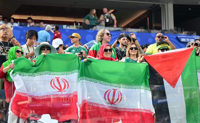 Iranian fans show a Palestinian flag among Iranian flags ahead of the 2026 World Cup Group G football match between Iran and New Zealand at Los Angeles Stadium in Inglewood on June 15, 2026.  (Photo by Frederic J. Brown / AFP)