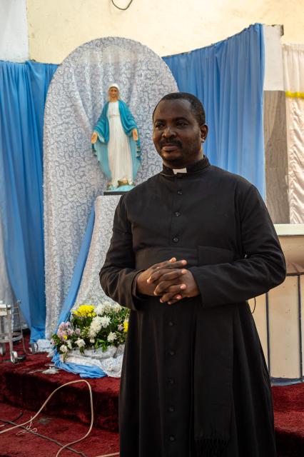 Father Jean-Pierre Mongambi, a Congolese priest who uses rap music to spread the Christian faith, poses for a portrait inside the Bienheureuse Anuarite parish in Kinshasa on May 17, 2026. Jean-Pierre Mongambi, also known as “the rapping priest,” roams the most deprived neighbourhoods of the Congolese capital to evangelise young people.
He has become a celebrity in the DRC, and beyond, with rap tracks that reprise psalms and prayers, and concerts widely shared on social media. (Photo by Hardy BOPE / AFP)