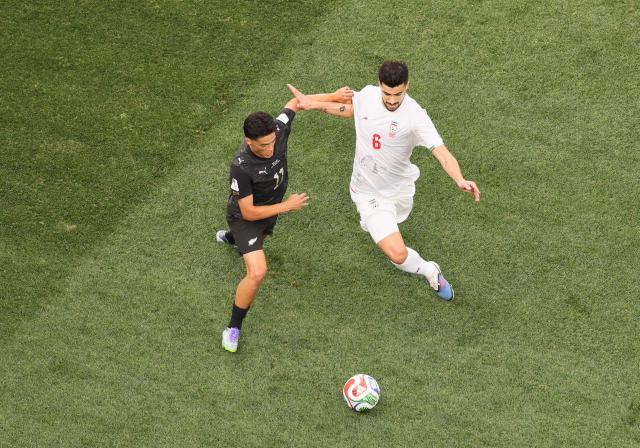New Zealand's forward #11 Elijah Just and Iran's midfielder #06 Saeid Ezatolahi fight for the ball during the 2026 World Cup Group G football match between Iran and New Zealand at Los Angeles Stadium in Inglewood on June 15, 2026.  (Photo by Etienne Laurent / AFP)