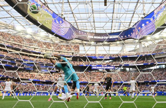 Iran's goalkeeper #01 Alireza Beiranvand concedes New Zealand's first goal scored by forward #11 Elijah Just during the 2026 World Cup Group G football match between Iran and New Zealand at Los Angeles Stadium in Inglewood on June 15, 2026.  (Photo by Frederic J. Brown / AFP)