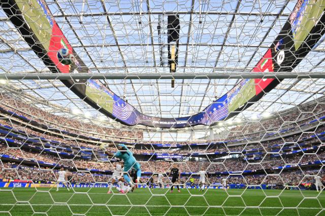 Iran's goalkeeper #01 Alireza Beiranvand concedes New Zealand's first goal scored by forward #11 Elijah Just during the 2026 World Cup Group G football match between Iran and New Zealand at Los Angeles Stadium in Inglewood on June 15, 2026.  (Photo by Frederic J. Brown / AFP)