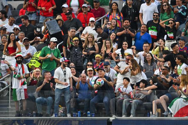 A fan catches the ball during the 2026 World Cup Group G football match between Iran and New Zealand at Los Angeles Stadium in Inglewood on June 15, 2026.  (Photo by Patrick T. Fallon / AFP)