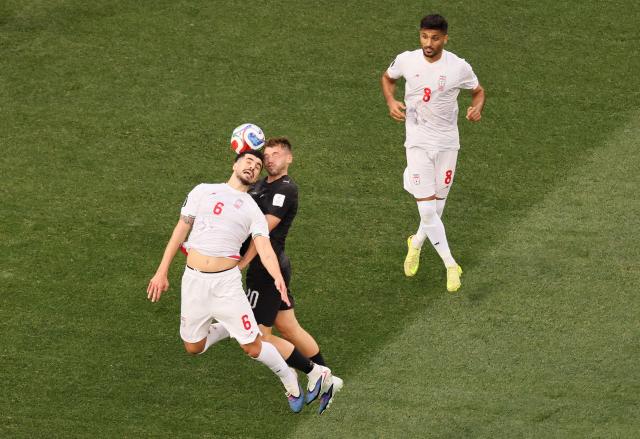 Iran's midfielder #06 Saeid Ezatolahi and New Zealand's forward #20 Callum McCowatt fight for the ball past Iran's midfielder #08 Mohammad Mohebbi during the 2026 World Cup Group G football match between Iran and New Zealand at Los Angeles Stadium in Inglewood on June 15, 2026.  (Photo by Etienne Laurent / AFP)