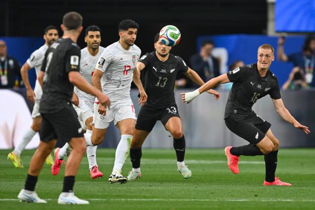 New Zealand's defender #16 Finn Surman (R) looks at the ball during the 2026 World Cup Group G football match between Iran and New Zealand at Los Angeles Stadium in Inglewood on June 15, 2026.  (Photo by Patrick T. Fallon / AFP)