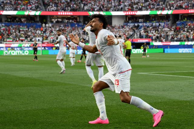 Iran's defender #23 Ramin Rezaeian celebrates scoring his team's first goal during the 2026 World Cup Group G football match between Iran and New Zealand at Los Angeles Stadium in Inglewood on June 15, 2026.  (Photo by Patrick T. Fallon / AFP)