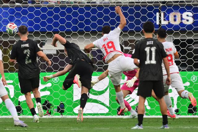 Iran's defender #19 Ali Nemati heads the ball and scores a goal which was later disallowed for offside during the 2026 World Cup Group G football match between Iran and New Zealand at Los Angeles Stadium in Inglewood on June 15, 2026.  (Photo by Frederic J. Brown / AFP)