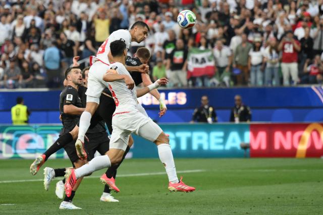 Iran's defender #19 Ali Nemati heads the ball and scores a goal which was later disallowed for offside during the 2026 World Cup Group G football match between Iran and New Zealand at Los Angeles Stadium in Inglewood on June 15, 2026.  (Photo by Patrick T. Fallon / AFP)