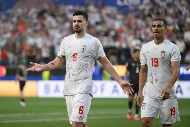 Iran's defender #19 Ali Nemati (R) and Iran's midfielder #06 Saeid Ezatolahi (L) react after a goal which was later disallowed for offside during the 2026 World Cup Group G football match between Iran and New Zealand at Los Angeles Stadium in Inglewood on June 15, 2026.  (Photo by Patrick T. Fallon / AFP)