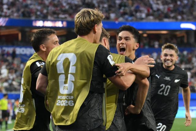 New Zealand's forward #11 Elijah Just celebrates with teammates after scoring his team's second goal during the 2026 World Cup Group G football match between Iran and New Zealand at Los Angeles Stadium in Inglewood on June 15, 2026.  (Photo by Patrick T. Fallon / AFP)
