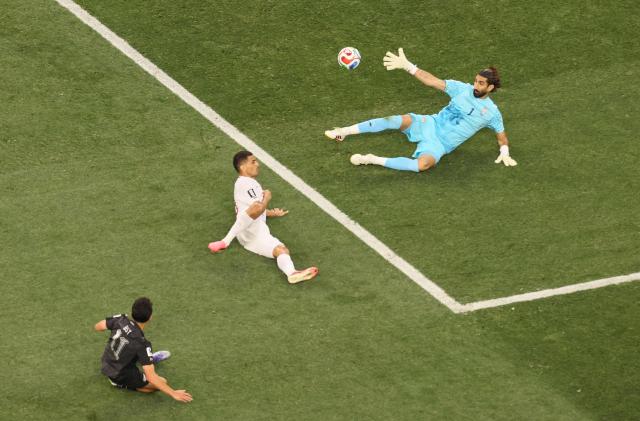 New Zealand's forward #11 Elijah Just scores his team's second goal past Iran's goalkeeper #01 Alireza Beiranvand during the 2026 World Cup Group G football match between Iran and New Zealand at Los Angeles Stadium in Inglewood on June 15, 2026.  (Photo by Etienne Laurent / AFP)