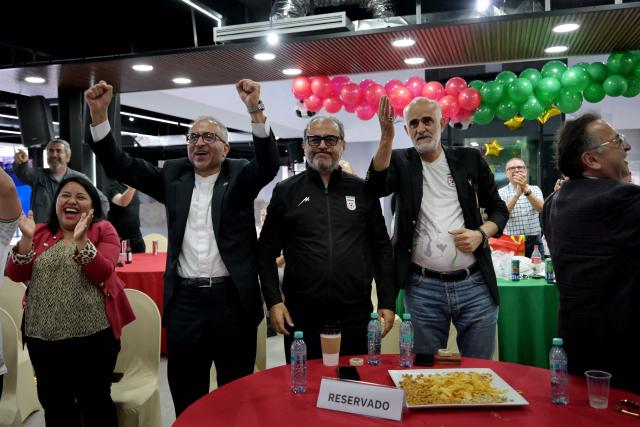 Iran's ambassador to Mexico Abolfazl Pasandideh (2nd-L) and First Vice President of the Islamic Republic of Iran Football Federation Mehdi Mohammad Nabi (2nd-R) celebrate as they watch the 2026 World Cup Group G football match between Iran and New Zealand at the Chamber of Commerce in Tijuana, Mexico on June 15, 2026. (Photo by Guillermo Arias / AFP)